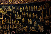Wat Xieng Thong temple in Luang Prabang, Laos. Detail of the  intricate gold stencilling on black lacquer that decorate the walls of the sim. 
